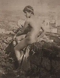 Vincenzo Galdi seated outdoors, wearing a robe, photographed by Wilhelm von Plüschow