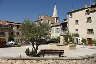 The village square with a fountain, in Saint-Didier