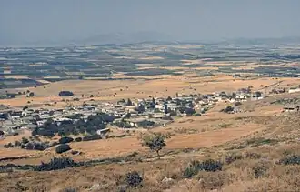 Photograph of a small town and farms taken from an elevation