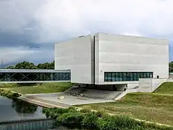 Śródka's Porta Posnania with steel-glass footbridge over small right branch of Warta.