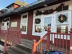The railway station in Beaconsfield is a red-painted historic wood building.