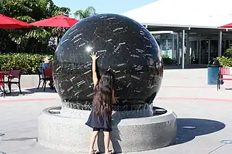 Celestial globe, weighing nine tons, being spun by a child at Kennedy Space Center Visitor Complex.