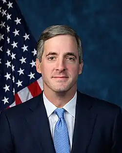 Official House portrait of Knott in front of the U.S. flag, wearing a black suit, white shirt, and blue tie.