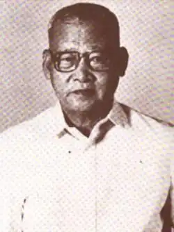 A man with glasses wearing a polo