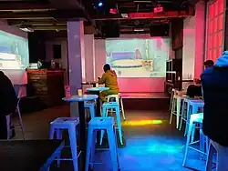 Photo of the interior of a bar with pink lighting