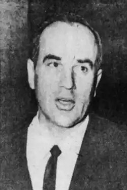 Black and white photo of DePugh in a suit