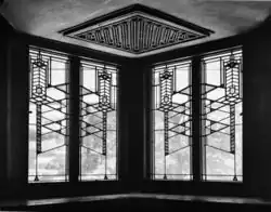 Geometric patterns on four windows as seen from inside the house