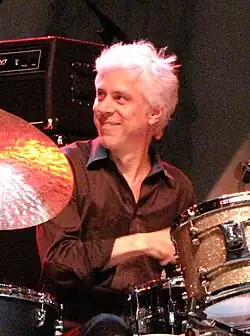 Rieflin smiling while drumming