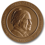 A gold medal embossed with Parks's face in profile