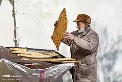 Bringing sangak from the oven to the cooling grates.
