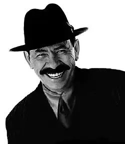 A black-and-white head shot of Scatman John