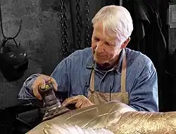 André Harvey works on a sculpture of a seaturtle