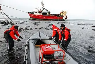The United States Coast Guard performing rescue operations for a ship grounded near St. George Island, Alaska