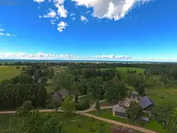 Houses with the Slīteres lighthouse in the background