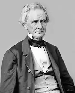 A man in late middle age in formal 19th-century dress