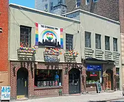 The exterior of Stonewall Inn in 2012, with a LGBTQ rights sign above the entrance