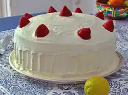 A large cake garnished with strawberries