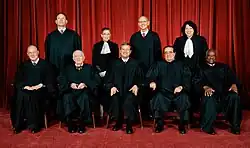 Group photo of United States Supreme Court Justices from 2009. Optional formal dress can be seen under the robes, such as bow ties. Justice Sonia Sotomayor and Justice Ruth Bader Ginsburg also wear lace jabots.
