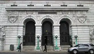 Photograph of the Chambers Street entrance showing three double-height arched doorways