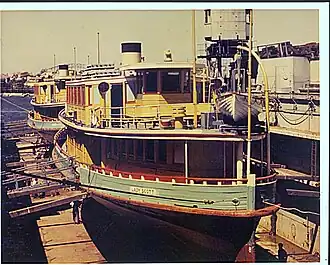 Dry docked 1960s in her 1937 yellow and green livery and short diesel funnel.