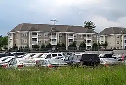 Three-story apartment buildings and a parking lot