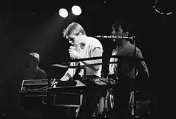 Graeme Synold (centre), Tony Ameneiro (right) and Ian Robertson (background) performing at the Trade Union Club in Sydney, 1982