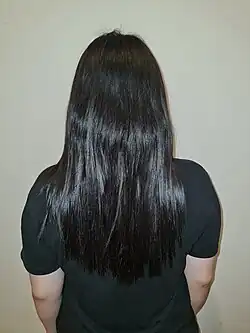 An Indonesian adolescent girl with mid-back length hair