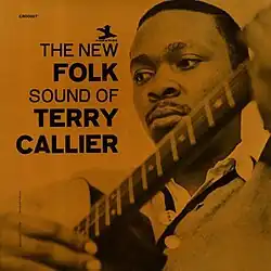 A deeply-colored sepia photo of Callier with an acoustic guitar