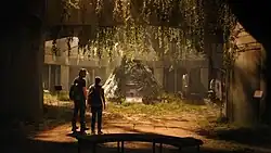 Joel and Ellie look upon a space capsule