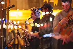 Three of the band on stage. From left to right: Liam Halliwell, Mark Rogers and Zac Denton.