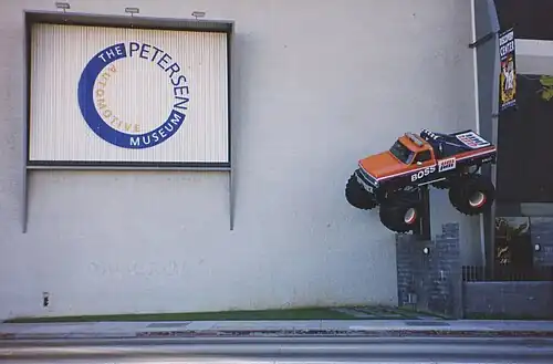 Classic Boss Ampm Monster Truck hanging from the wall, at museum display, before renovation
