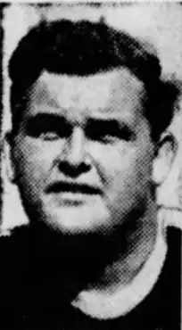 Picture of Croft's head and shoulders, he is looking to the left of the image