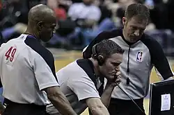 Image 12NBA officials Monty McCutchen (center), Tom Washington (#49) and Brent Barnaky reviewing a play. (from Official (basketball))
