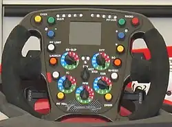 Yellow button marked "over" on the top left side of a 2008 Formula 1 steering wheel Toyota