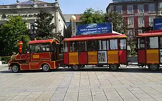 A trackless train with its tractor unit resembling a steam locomotive