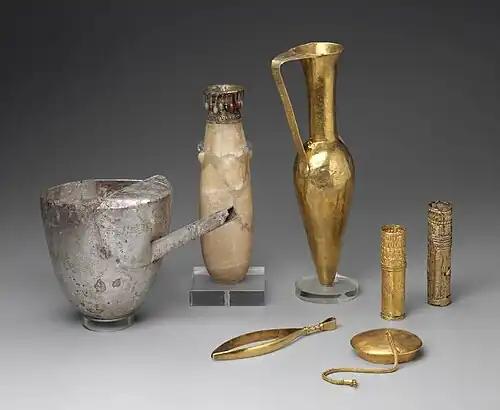 Artifacts including large metal tweezers, decorated and inscribed vessels, gold sheaths, and a ewer marked for King Aspelta found in Nuri pyramid 8. Museum of Fine Arts, Boston.