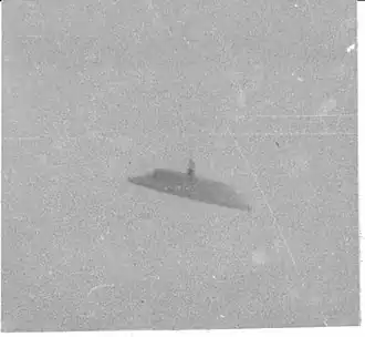 vague profile of UFO shaped similar to a car's side mirror