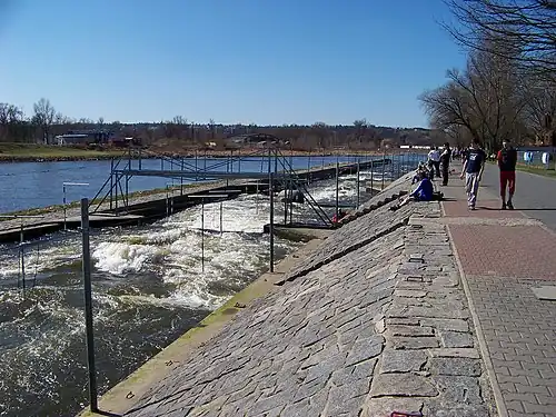 The mid-course bridge and below. For competitions, the sloped right bank is covered with seating.