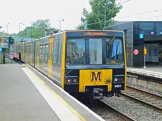 A Metrocar at Chillingham Road in 2024, branded in the current black and yellow colour scheme.