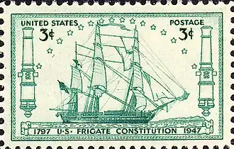 A postage stamp accurately depicts Constitution at sail. The ship sails to the right side of the stamp.