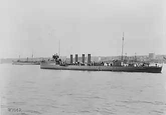 USS Jouett (DD-41) anchored in the Hudson River off New York City, during the October 1912 Naval Review. USS Rhode Island (BB-17) is in the left background.
