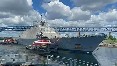 USS Little Rock getting towed into Philadelphia Navy Yard by tug boats