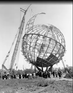 A crane installing the last segment of the Unisphere