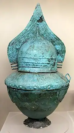 Cinerary vase with lid in the shape of a high-crested helmet, bronze, Necropolis of the Four Fountains, shaft tomb AA1, 750 BC.