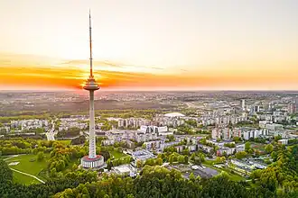 Very tall transmission tower, surrounded by smaller buildings