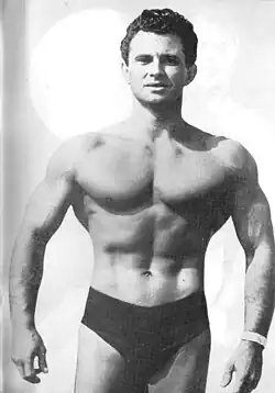 Vince Gironda, only wearing underwear, in a black-and-white magazine image