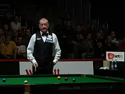 Steve Davis looking at a snooker table