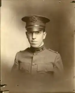 World War One Service photograph of a young man in fitted US Army dress. Photograph is in black and white, but faded yellow slightly with age.