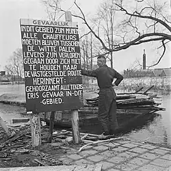 Warning sign for minefield in inundated area.