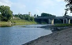 The Wabash River at Lafayette, Indiana, showing the Myers Pedestrian Bridge, and the Amtrak station; the river flows from left to right (north to south). This stretch is notable for large, sandy deposits.